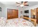 Well-lit bedroom featuring ceiling fan, built-in closet, and a doorway to hallway at 1268 Harris Road Rd, Lawrenceville, GA 30043