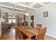 Beautiful dining room with coffered ceilings, wood floors and an elegant chandelier at 1268 Harris Road Rd, Lawrenceville, GA 30043