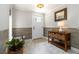 Inviting entryway with tiled floors, storage console and tiled accent wall at 1268 Harris Road Rd, Lawrenceville, GA 30043