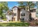 Rear exterior showcasing a large multi-story home with a deck, patio, and manicured lawn at 1268 Harris Road Rd, Lawrenceville, GA 30043