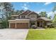 Charming two-story home with a manicured lawn, a two-car garage, and beautiful landscaping at 1268 Harris Road Rd, Lawrenceville, GA 30043