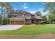 Charming two-story home with landscaped front yard, two-car garage, and mature trees at 1268 Harris Road Rd, Lawrenceville, GA 30043