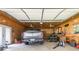 Spacious garage with a truck, lawnmower, work bench, and overhead lighting at 1268 Harris Road Rd, Lawrenceville, GA 30043