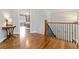 Elegant upstairs hallway boasts gleaming wood floors and decorative wrought iron railing at 1268 Harris Road Rd, Lawrenceville, GA 30043