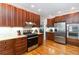 Traditional kitchen features wood cabinets, stainless steel appliances, granite countertops and hardwood floors at 1268 Harris Road Rd, Lawrenceville, GA 30043