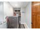 Well-organized laundry room includes front load washer, shelves, and access to attic at 1268 Harris Road Rd, Lawrenceville, GA 30043
