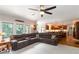 Spacious living area with large sectional, hardwood floors and kitchen in the background at 1268 Harris Road Rd, Lawrenceville, GA 30043