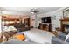 Open-concept living room featuring a fireplace, mounted tv and seamless flow to the kitchen at 1268 Harris Road Rd, Lawrenceville, GA 30043