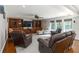 Bright and open living room with built-in shelving, a ceiling fan, and hardwood floors at 1268 Harris Road Rd, Lawrenceville, GA 30043