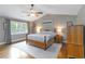 A primary bedroom with a fan, light gray walls, and hardwood floors at 1268 Harris Road Rd, Lawrenceville, GA 30043