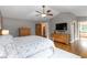 Main bedroom suite features hardwood floors, tv and recessed lighting at 1268 Harris Road Rd, Lawrenceville, GA 30043