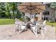 Stone patio with Adirondack chairs and an umbrella, perfect for outdoor gatherings at 1268 Harris Road Rd, Lawrenceville, GA 30043