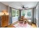 Sitting room features wood floors, neutral walls, and 3 windows at 1268 Harris Road Rd, Lawrenceville, GA 30043