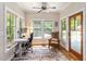 Sunroom features a desk, chair, windows, hardwood floors and a ceiling fan at 1268 Harris Road Rd, Lawrenceville, GA 30043