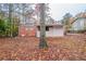 Home featuring a backyard with mature trees and partial fencing at 1410 Willow Dr, Riverdale, GA 30296