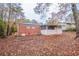 Home featuring a backyard with mature trees and partial fencing at 1410 Willow Dr, Riverdale, GA 30296