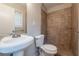 Simple bathroom design with a toilet, sink, and tiled shower area at 1410 Willow Dr, Riverdale, GA 30296