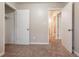 Bedroom with neutral walls and carpet featuring access to a bathroom and closet at 1410 Willow Dr, Riverdale, GA 30296