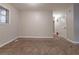 Bright room with soft carpet, a window for natural light, and a door to additional space at 1410 Willow Dr, Riverdale, GA 30296