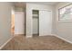 Bedroom with neutral walls and carpet featuring a window and closet at 1410 Willow Dr, Riverdale, GA 30296