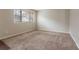 Spacious bedroom featuring neutral walls, carpeted floors, and a large window offering natural light at 1410 Willow Dr, Riverdale, GA 30296