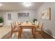 Inviting dining room with a wooden table, seating for six, and modern decor at 1410 Willow Dr, Riverdale, GA 30296