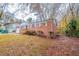 Brick home exterior, front yard with mature trees, and ample natural light at 1410 Willow Dr, Riverdale, GA 30296