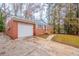 Single-Gathering home featuring an attached garage, driveway, and a well-maintained lawn at 1410 Willow Dr, Riverdale, GA 30296