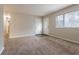 Spacious living room featuring plush carpeting and a bright front entryway at 1410 Willow Dr, Riverdale, GA 30296