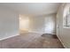 Spacious living room showcasing new carpeting and a welcoming front entrance at 1410 Willow Dr, Riverdale, GA 30296