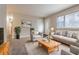 Cozy living room featuring neutral tones, plush seating, and ample natural light at 1410 Willow Dr, Riverdale, GA 30296