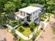 Aerial view of a modern house with landscaped yard, sidewalks and surrounding greenery at 3117 Robinson Ave, Scottdale, GA 30079