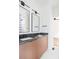 Modern bathroom featuring dual vanities, sleek mirrors, and a glass-enclosed shower in the background at 3117 Robinson Ave, Scottdale, GA 30079