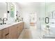 Bright bathroom with wood cabinets, dual vanities, black fixtures, and a free-standing tub at 3117 Robinson Ave, Scottdale, GA 30079