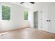 Neutral bedroom featuring two windows, an ensuite bathroom, and beautiful hardwood floors at 3117 Robinson Ave, Scottdale, GA 30079