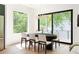 Elegant dining room with modern lighting, a stylish table, and sliding doors to a scenic outdoor space at 3117 Robinson Ave, Scottdale, GA 30079