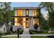 Modern home exhibiting a well-lit porch and manicured landscaping at 3117 Robinson Ave, Scottdale, GA 30079