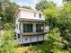 House featuring a spacious deck with ceiling fans and a partially shaded backyard at 3117 Robinson Ave, Scottdale, GA 30079