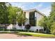 Modern two-story home with large windows, manicured landscaping and bright painted brick at 3117 Robinson Ave, Scottdale, GA 30079