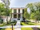 Modern home featuring a covered porch, well-manicured lawn, and contemporary architectural details at 3117 Robinson Ave, Scottdale, GA 30079