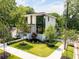 Stunning modern home showcasing a lush landscaped yard and architectural design at 3117 Robinson Ave, Scottdale, GA 30079
