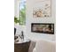 Living room fireplace with modern design and decorative painting of Santorini, Greece at 3117 Robinson Ave, Scottdale, GA 30079
