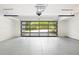Spacious garage with modern glass door and epoxy flooring with overhead mechanics at 3117 Robinson Ave, Scottdale, GA 30079