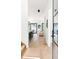 Bright hallway with hardwood floors leading to an open-concept kitchen and living area at 3117 Robinson Ave, Scottdale, GA 30079