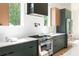 Modern kitchen featuring stainless steel appliances, quartz countertops, and ample natural light from large windows at 3117 Robinson Ave, Scottdale, GA 30079