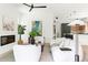 Open concept living area with modern fireplace flows into the kitchen with white and green accents and stainless steel appliances at 3117 Robinson Ave, Scottdale, GA 30079