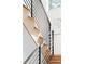 Staircase with wooden steps, sleek metal railings, and a piece of art on the white wall at 3117 Robinson Ave, Scottdale, GA 30079