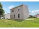 View of home's side and backyard, featuring vinyl siding, a concrete patio, and lawn at 7099 Skippingstone Way, Douglasville, GA 30134