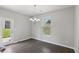 Bright dining area with modern lighting, views of the backyard and updated flooring at 7099 Skippingstone Way, Douglasville, GA 30134