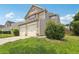 Two-story home with vinyl siding, a two-car garage, and well-maintained landscaping at 7099 Skippingstone Way, Douglasville, GA 30134